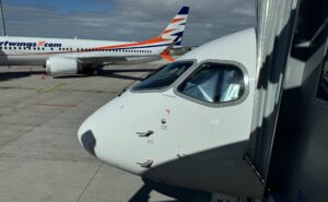 Czech Airlines branded Airbus A220-300 parked at the gate for Smartwings passengers. A Smartwings branded aircraft is in the background.