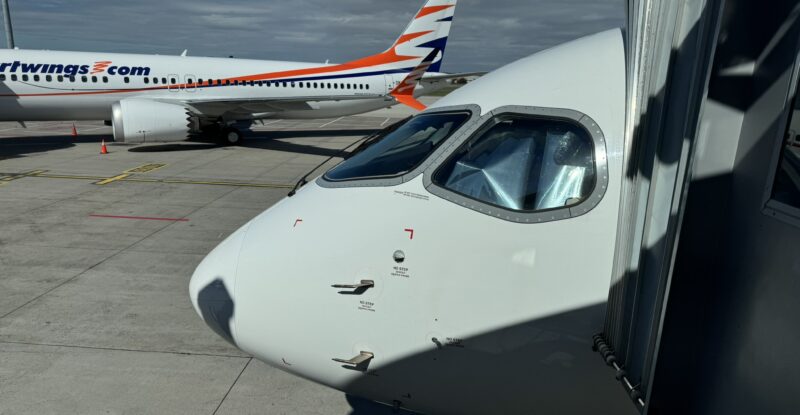 Czech Airlines branded Airbus A220-300 parked at the gate for Smartwings passengers. A Smartwings branded aircraft is in the background.