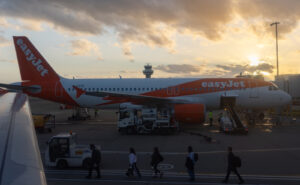 easyjet Airbus A319 at the gate ready for boarding during sunset.