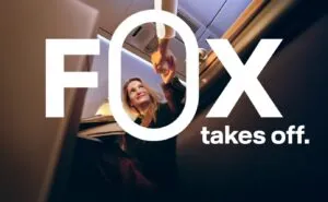 A passenger is sitting in an aircraft seat. "FOX takes off" is printed over the image.