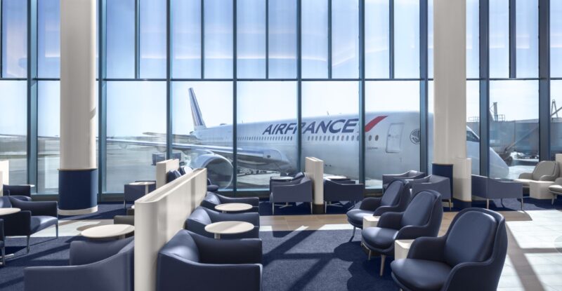 Large floor to ceiling windows line the wall of the Air France Business Lounge in Chicago Airport.