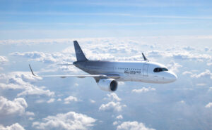 ACJ319neo inflight above white clouds.
