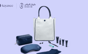 Riyadh Air amenity kit by Kayanee shows some contents such as eye mask, lotions, and a white bag for storage.