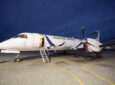 Aleutian Saab 2000 ready for boarding via jet stairs at night.