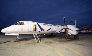 Aleutian Saab 2000 ready for boarding via jet stairs at night.