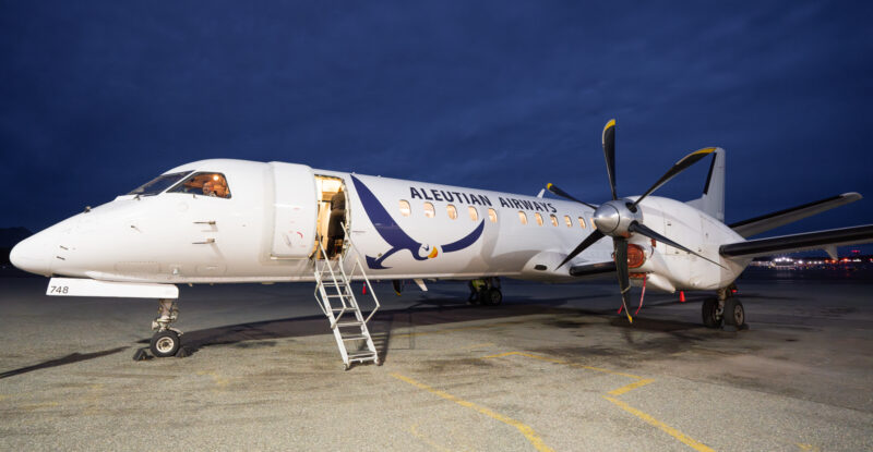 Aleutian Saab 2000 ready for boarding via jet stairs at night.
