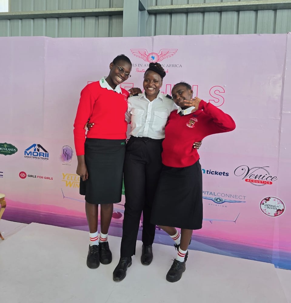 Maseka Kithinji posing with two young girls