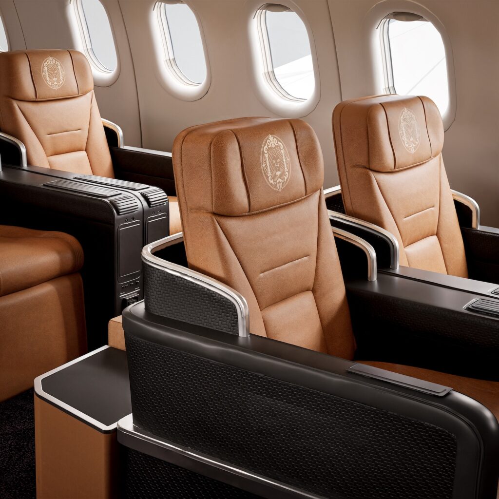 Close up of seats on board with burnt orange covers and dark furniture 