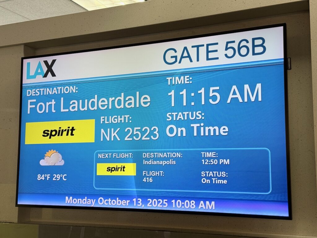 Screen at the gate indicating the flight and flight time