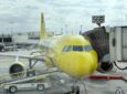 Spirit Airlines' yellow A320 parked at the gate.