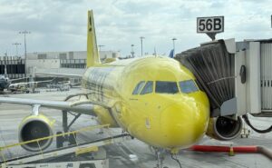 Spirit Airlines' yellow A320 parked at the gate.
