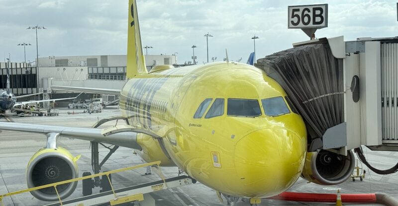 Spirit Airlines' yellow A320 parked at the gate.