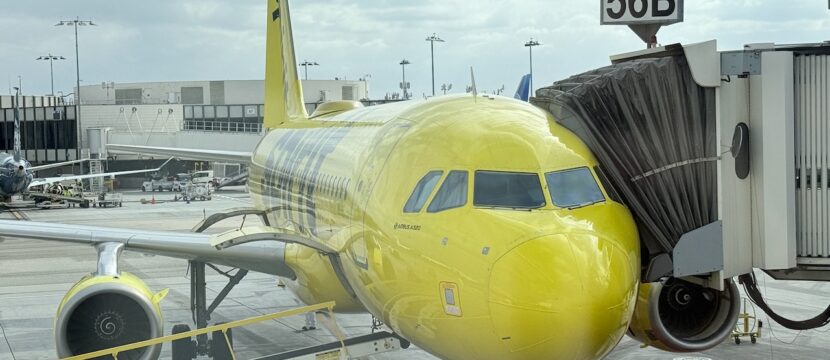 Spirit Airlines' yellow A320 parked at the gate.
