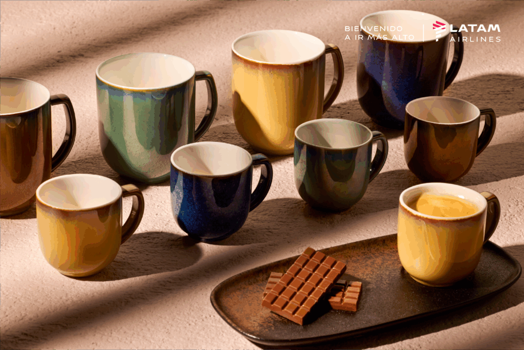 LATAM coffee mugs in various South America-inspired colors are on display.