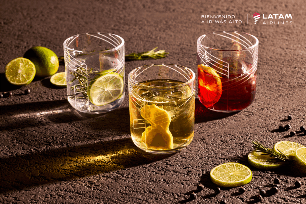 Three cocktail drinks on display on a paved area.