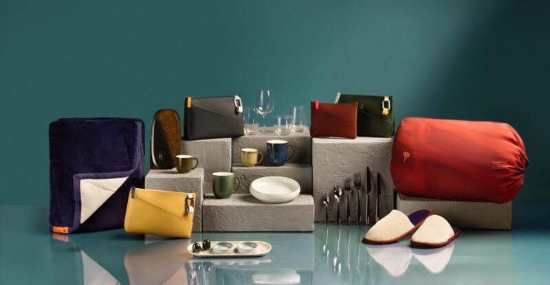 Various new LATAM amenity kits are set out on a green background. The kits range in colors, and are inspired by LATAM's South American identity.