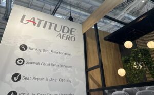 Latitude Aero signage at AIX 2024, touting the firm's seat and sidewall panel refurbishment services