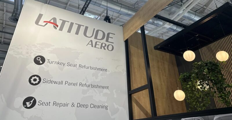 Latitude Aero signage at AIX 2024, touting the firm's seat and sidewall panel refurbishment services