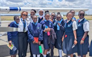 Maseka Kithinji posing with girls in the program.