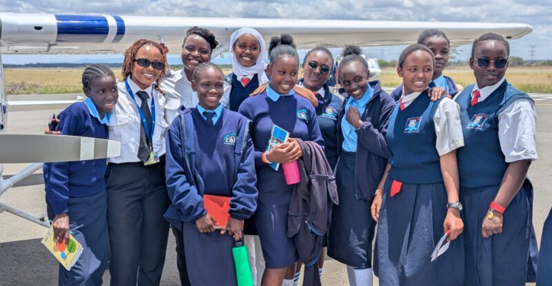 Maseka Kithinji posing with girls in the program.