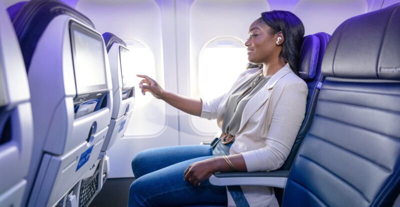 Female passenger enjoys IFE on a United Airlines aircraft