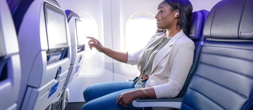Female passenger enjoys IFE on a United Airlines aircraft