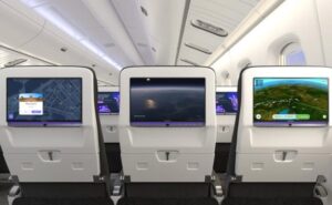 3 seats in an aircraft from the back showing different aspects on each of their IFE screens.
