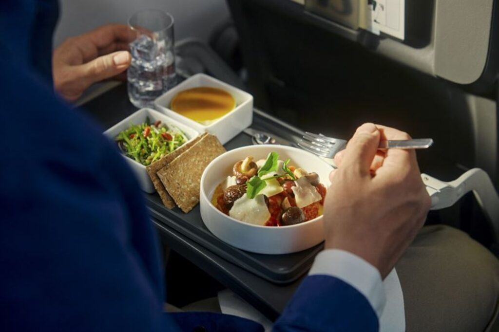 SAS meal is being enjoyed and is laid out on the aircraft tray table. 