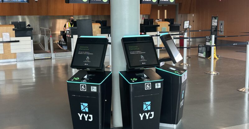 Embross' advanced Odyssey Common Use Passenger Processing System (CUPPS) with Flair signage in the background.
