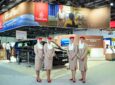 Emirates' stand at the 7th edition of AccessAbilities Expo in Dubai World Trade Centre with 4 flight crew members in uniform standing in front of it.