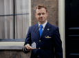 KLM crew member holding the Delft Blue House.