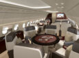 Current (not yet upgraded) ACJ318 Elite cabins of the dining area. A small round table with individual seats around it.