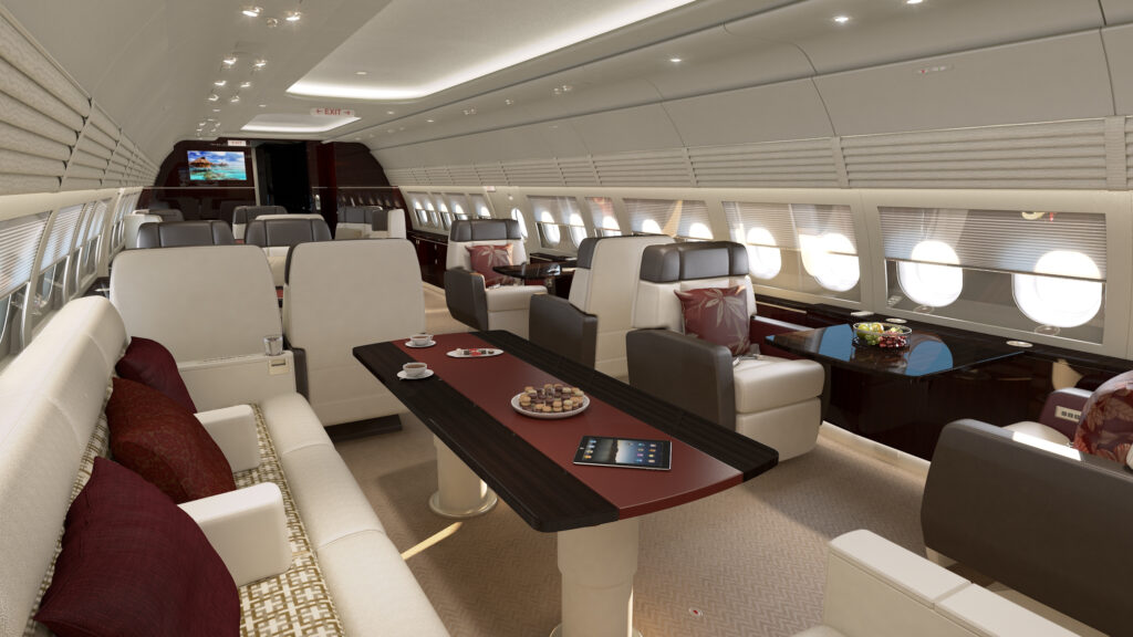 A current (not yet upgraded) ACJ318 Elite cabin dinning area featuring a long table with a sofa and recliners.