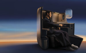 Passenger sits in Cathay's Aria suite with calm lighting all around