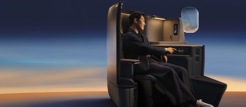 Passenger sits in Cathay's Aria suite with calm lighting all around
