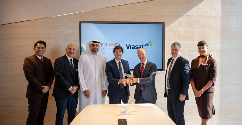 Viasat and Etihad executives celebrate their pact at the Dubai Airshow