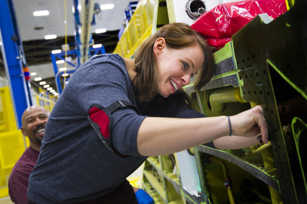Bekah Grace inspects the wing for FOD prior to customer inspection. 