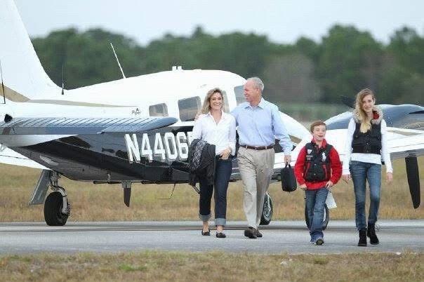 Grace Carlon and family walking from an aircraft