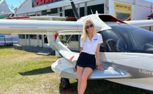 Grace Carlon leaning on an aircraft.