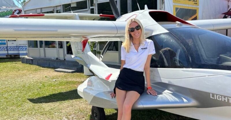 Grace Carlon leaning on an aircraft.