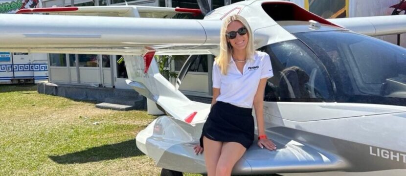 Grace Carlon leaning on an aircraft.