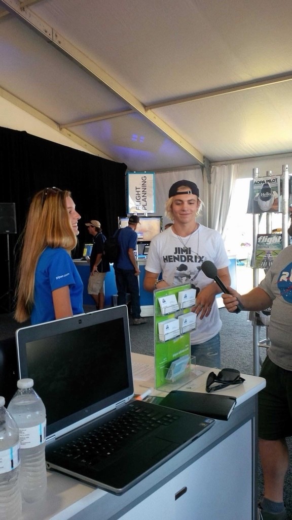 Grace Carlon is speaking to someone at an aviation event.