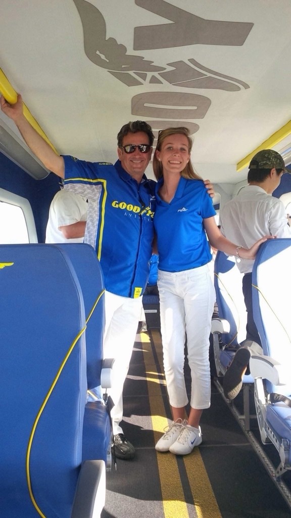 Grace Carlon posing with a friend in the cabin of an aircraft.