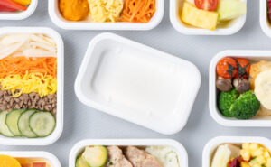 Various Korean Air meals on display in their new plant-based containers.