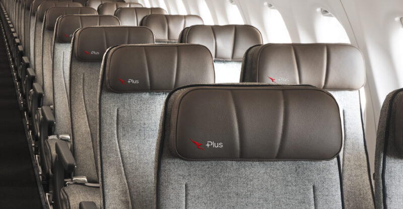 Qantas Economy Plus seats embossed with the branding on an A220