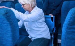 Woman is assisted to her seat with the Airchair for a seat transfer