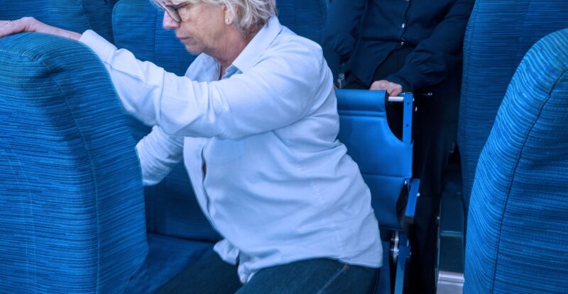 Woman is assisted to her seat with the Airchair for a seat transfer