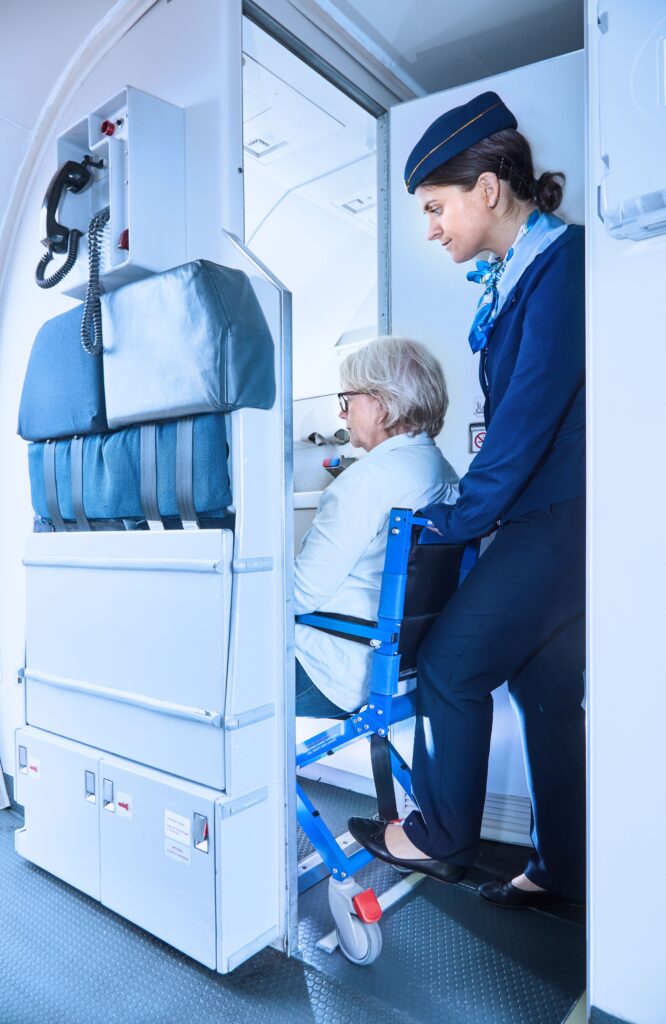 Airchair user is wheeled to the toilet