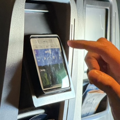 Passenger tries to rest their device on the IFE bezel