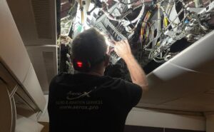 Vallair and AeroX employee installing Starlink on an aircraft.